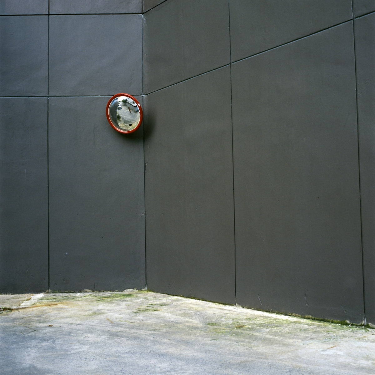 round gray and red wall mirror