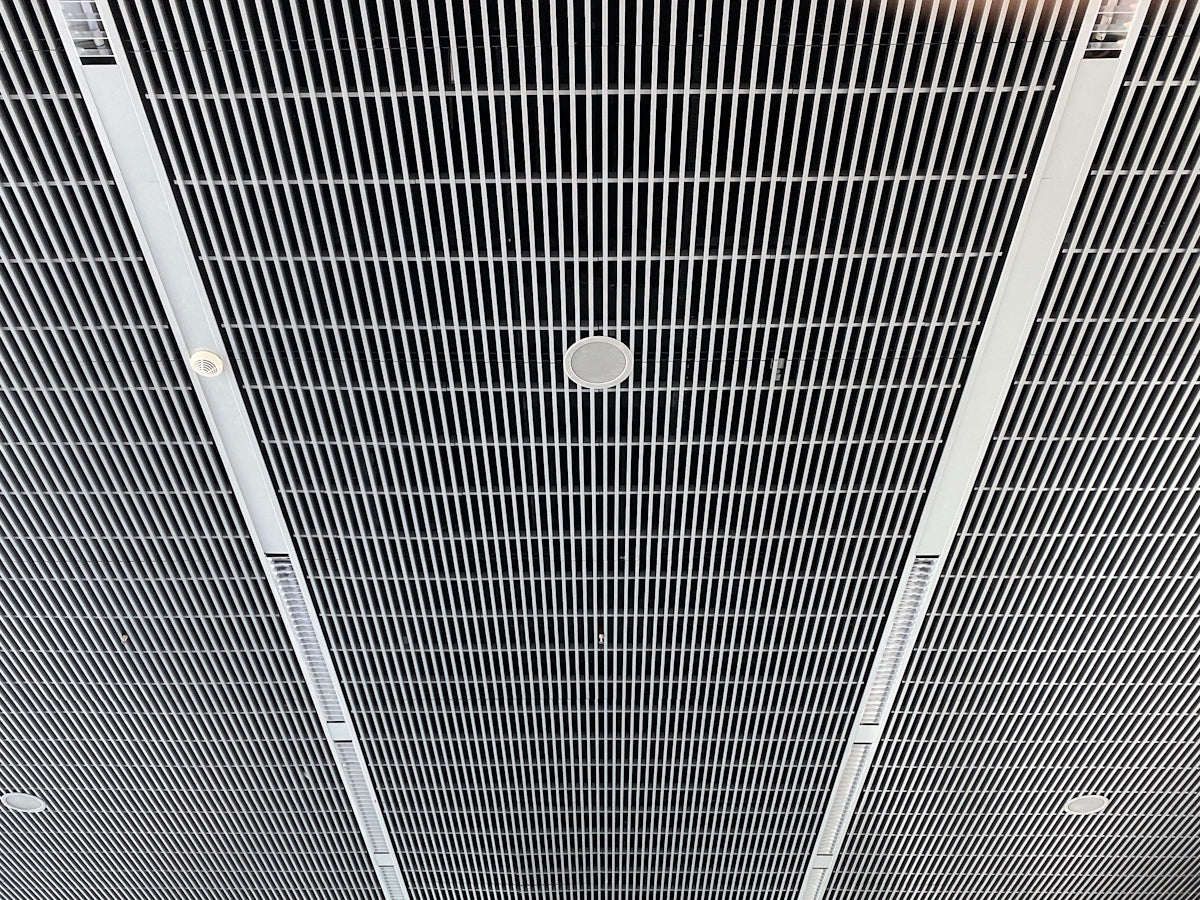 the ceiling of a building with a clock on it