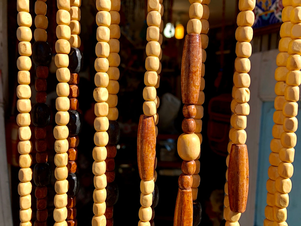 brown wooden beaded necklace on brown wooden rack