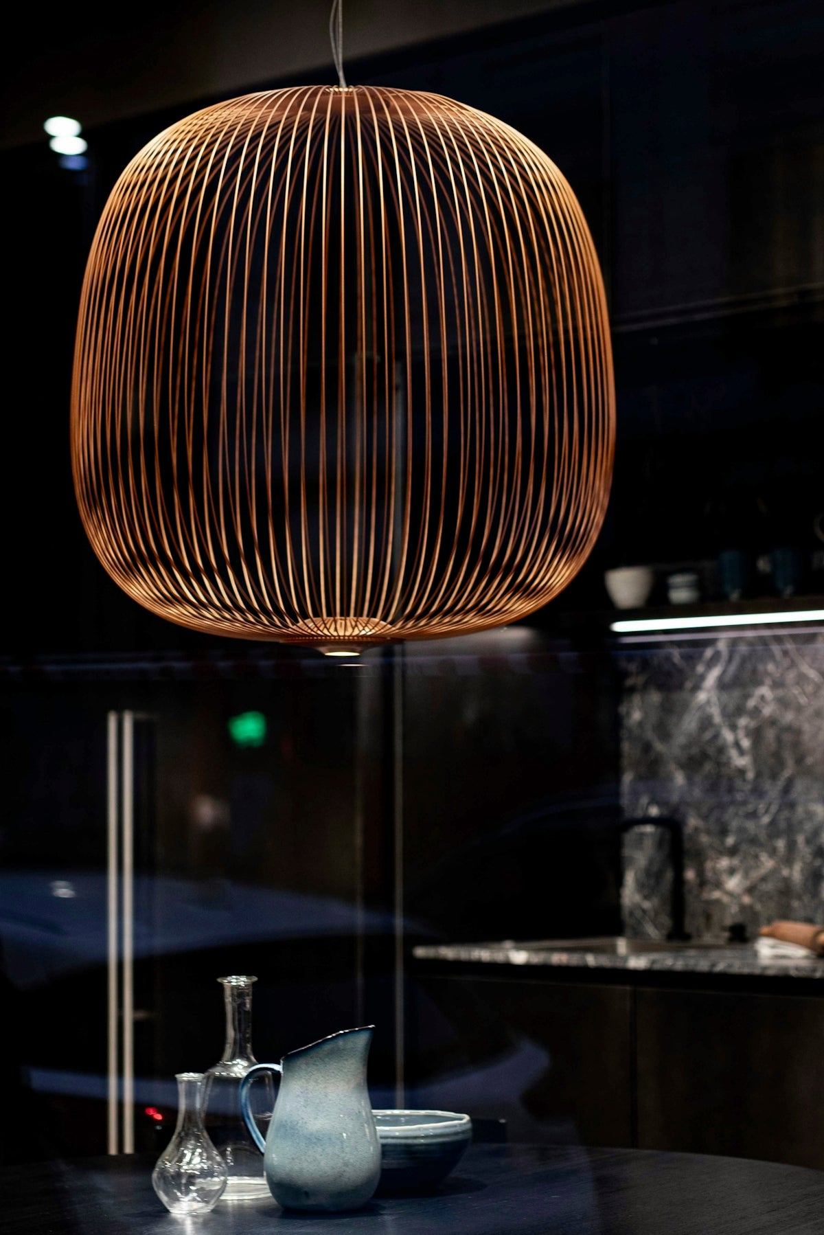 brown round pendant lamp turned on in room