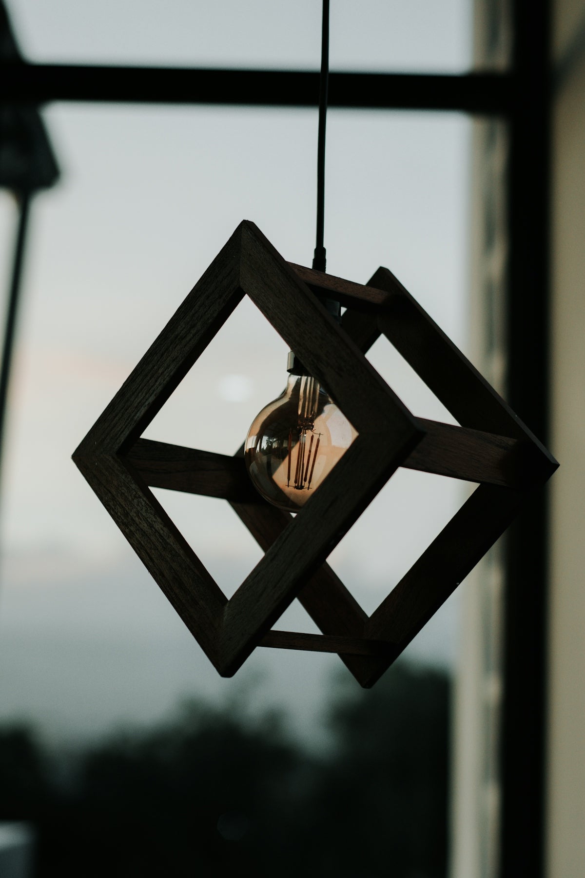 a light bulb hanging from a wooden frame