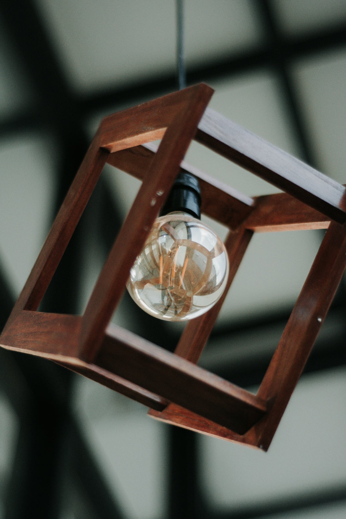 a wooden light fixture hanging from a ceiling