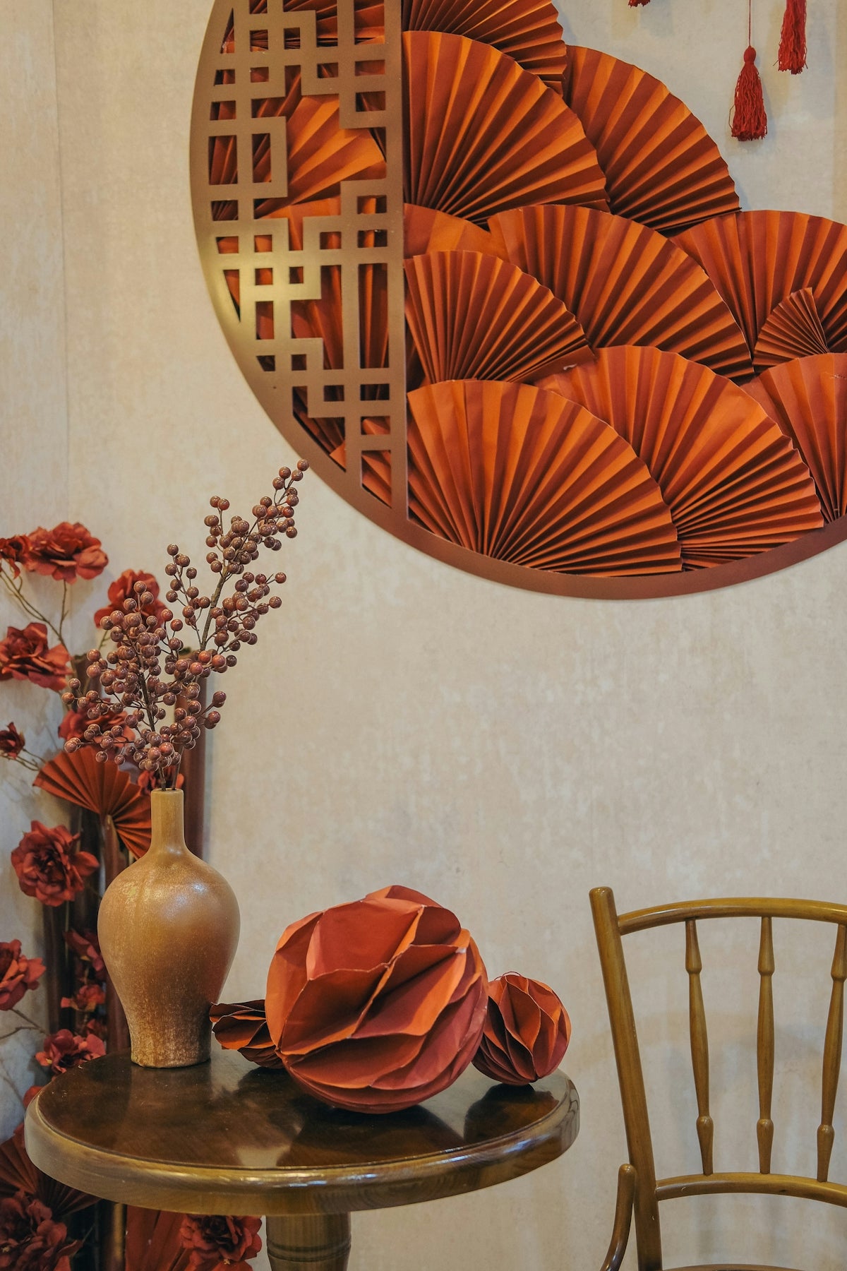 a table with a vase of flowers and a mirror on the wall