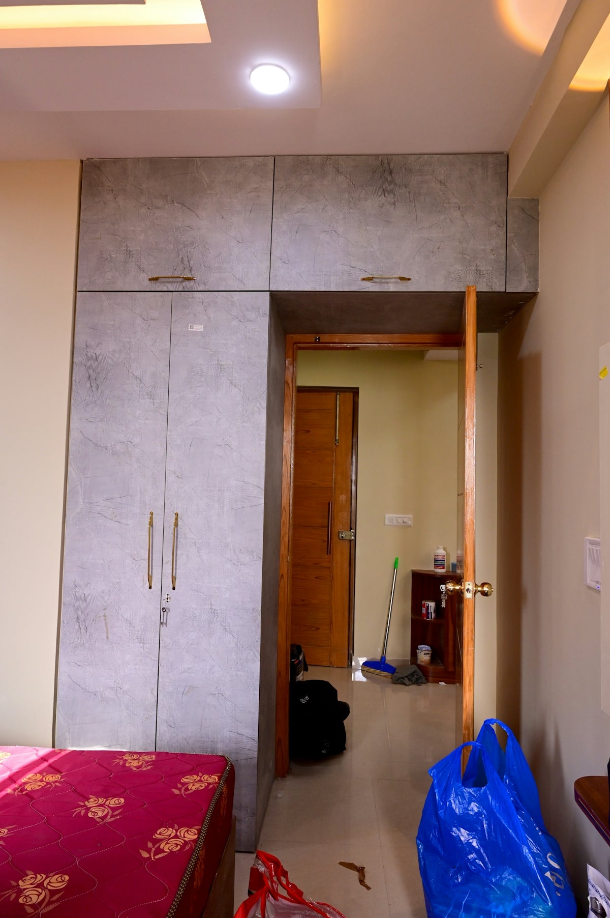 a room with a bed and a blue bag on the floor