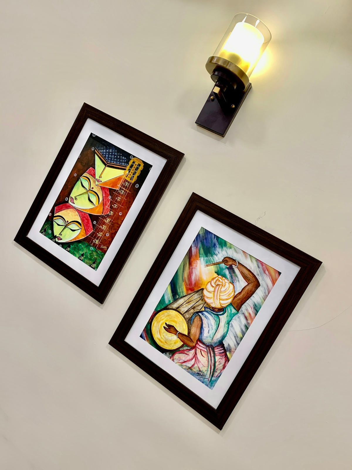 a couple of paintings hanging on a wall