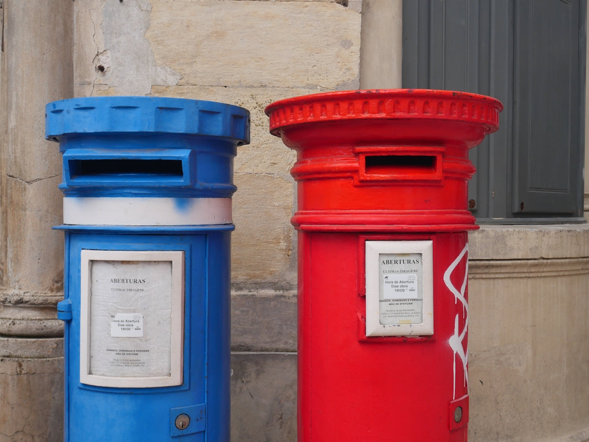 a couple of blue and red mailboxes
