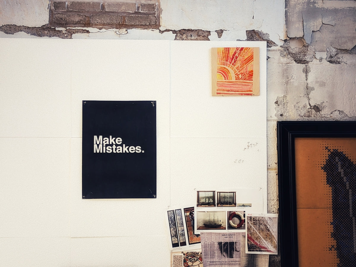 a sign that says make misstakes on a wall