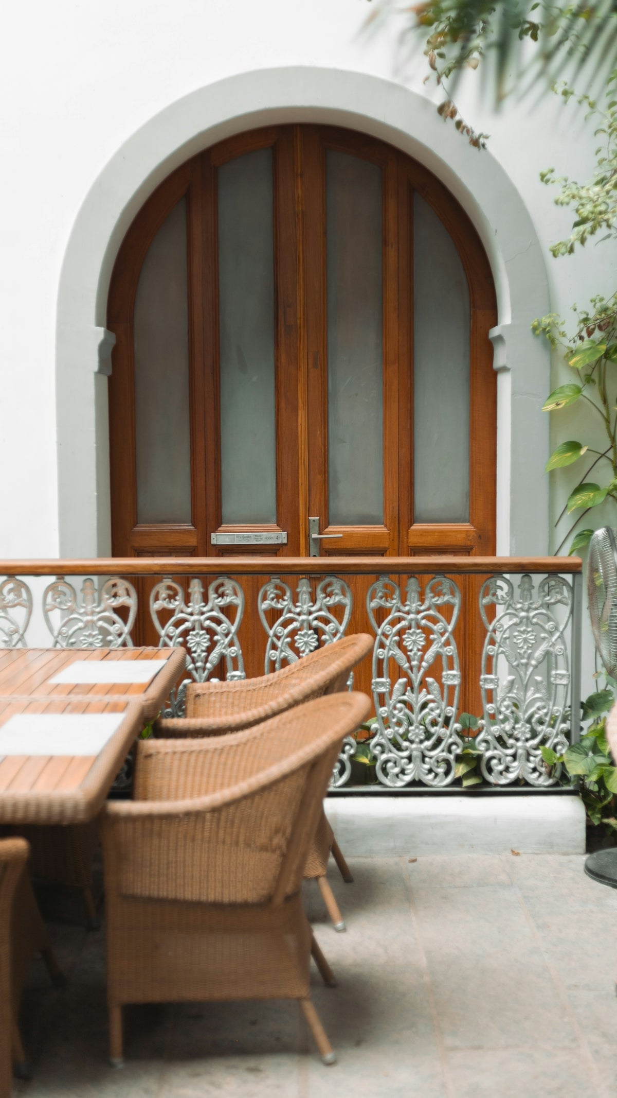 a table and chairs on a patio with a door in the background
