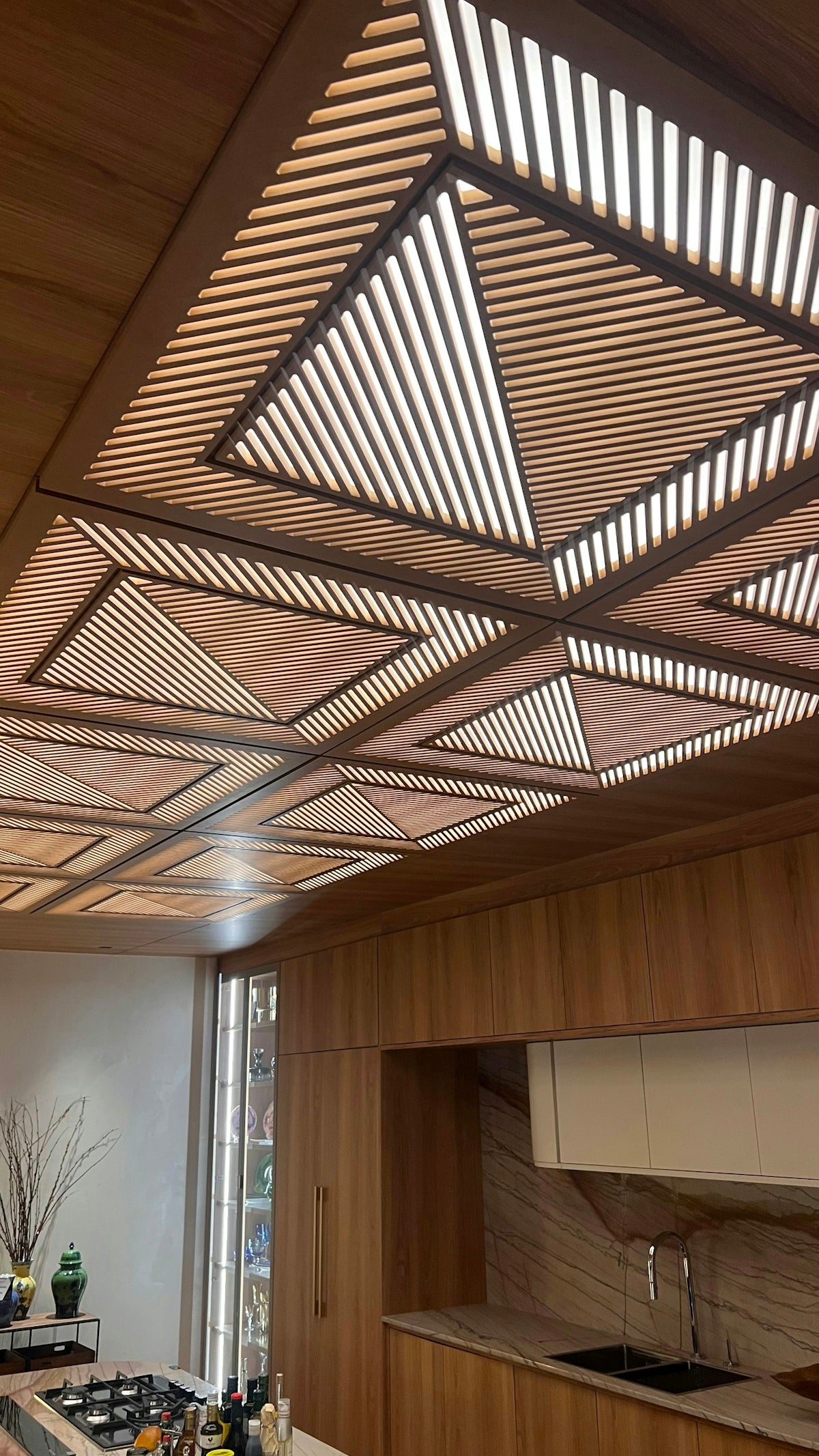 a kitchen with a stove top oven sitting under a wooden ceiling