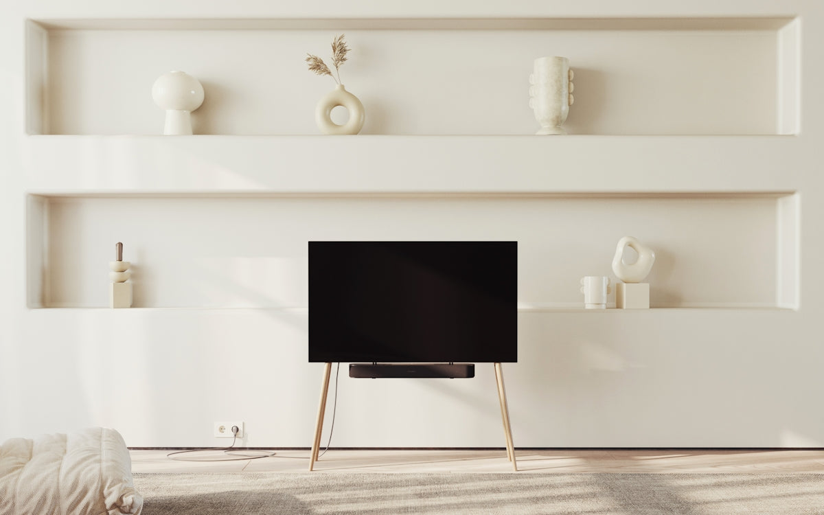 a flat screen tv sitting on top of a wooden stand