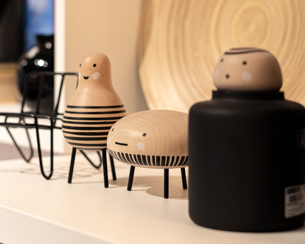 a couple of wooden toys sitting on top of a white shelf