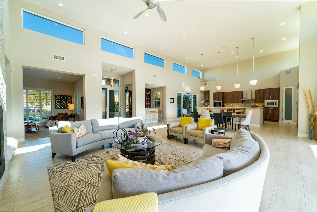 a living room filled with furniture and lots of windows