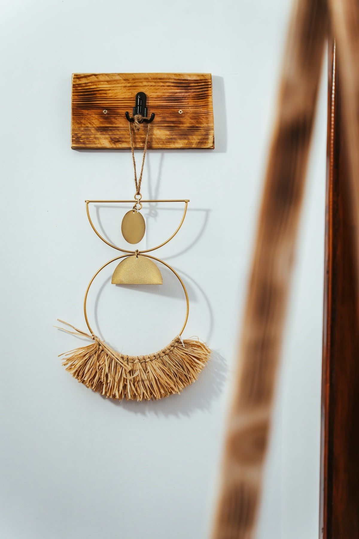 a pair of earrings hanging on a wall