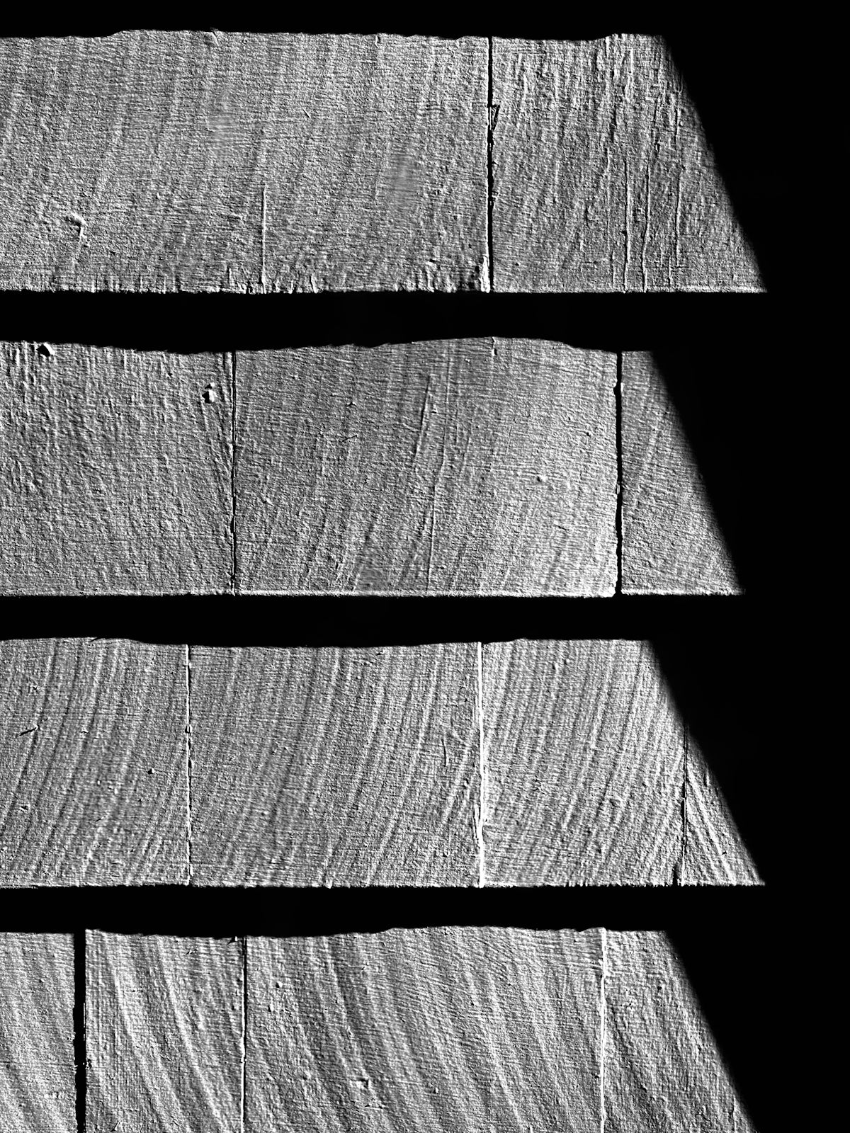 a black and white photo of a wooden wall