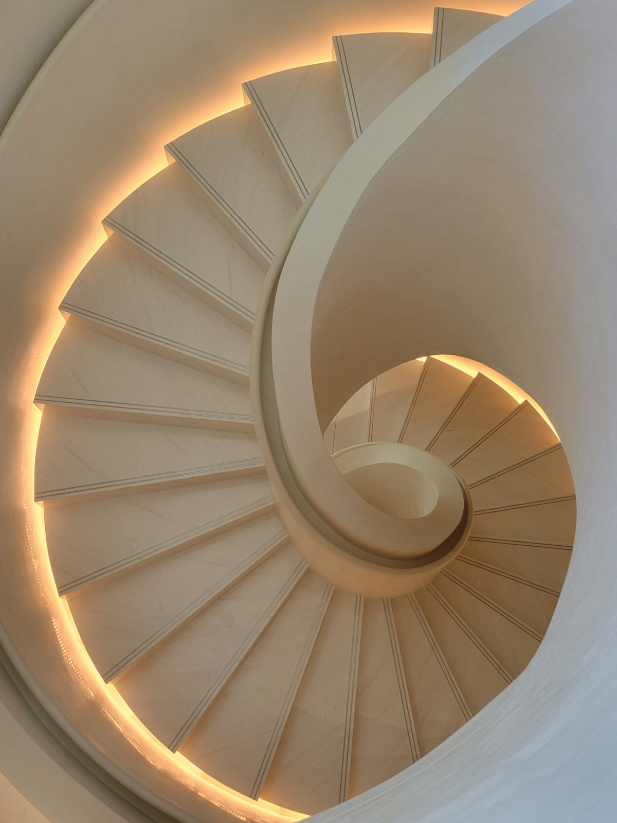A spiral staircase in a building with lights