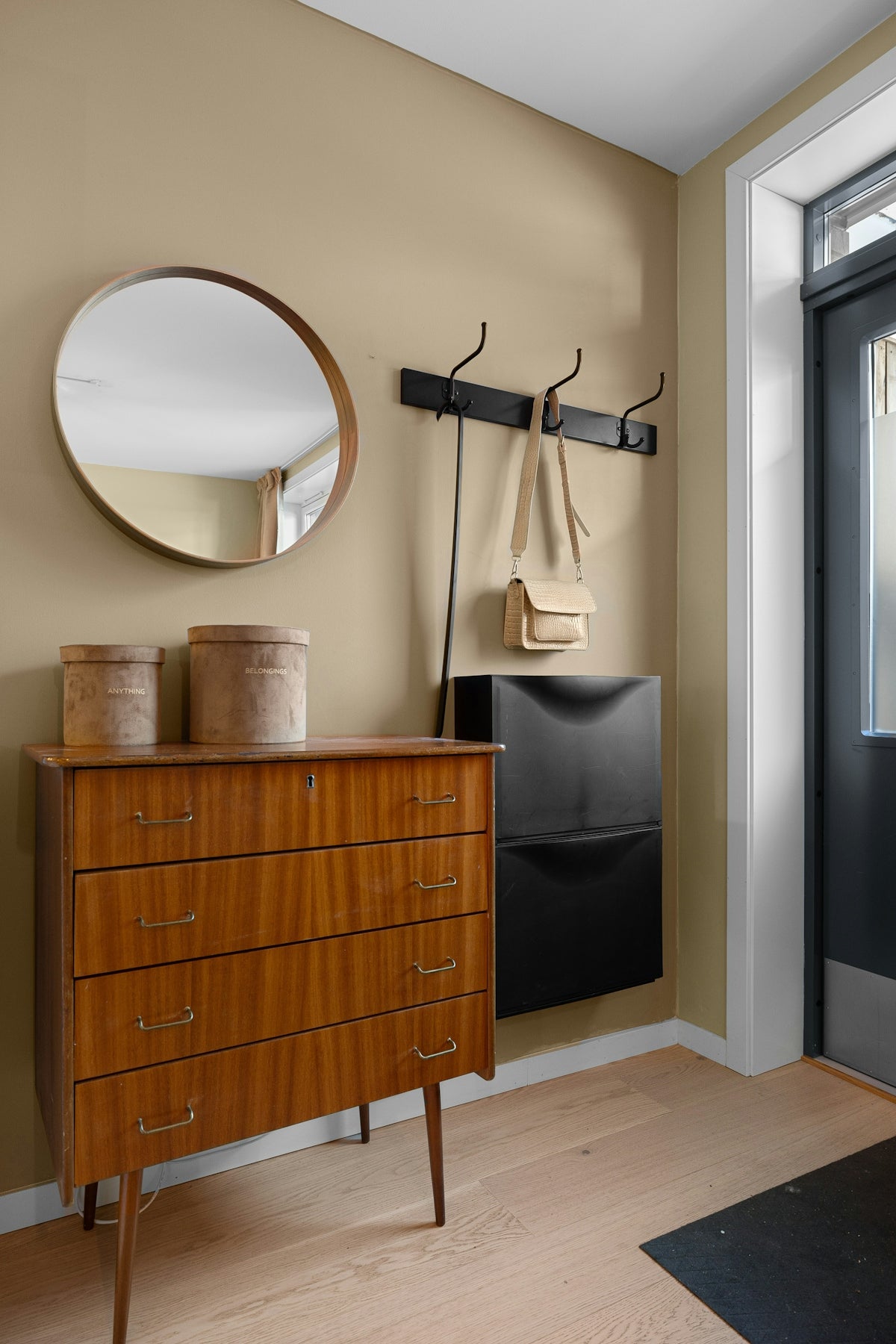 A room with a dresser and a mirror