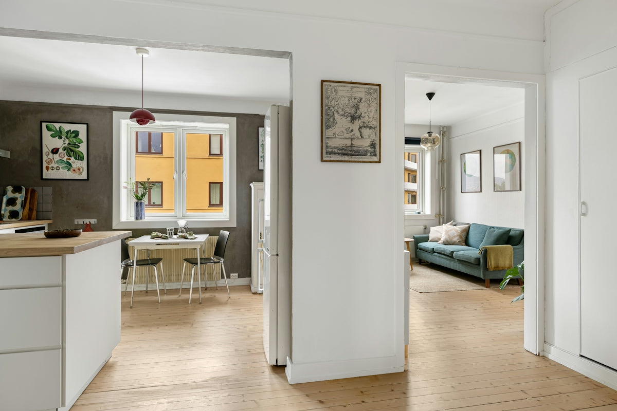 A kitchen and living room are shown in this image
