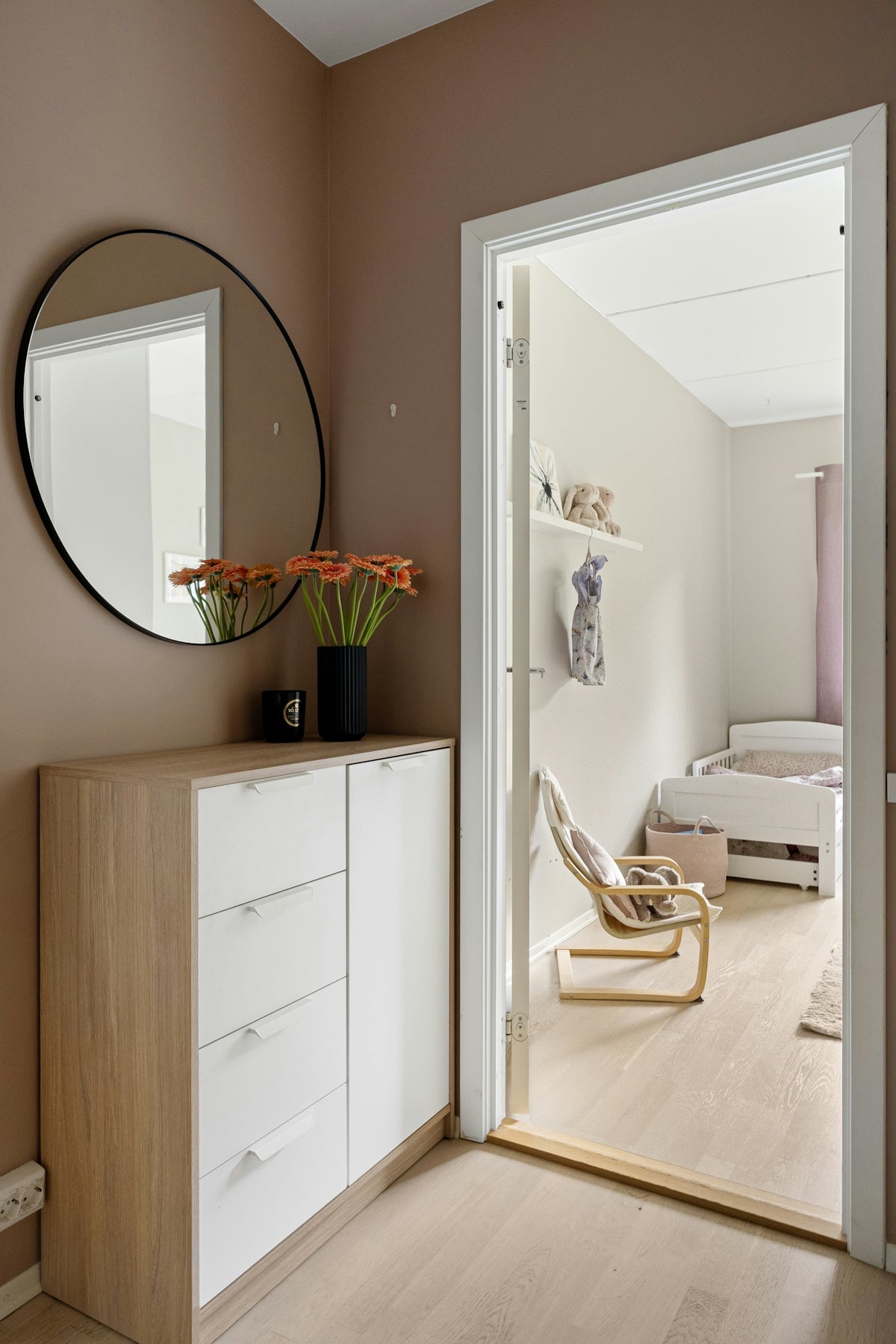 A room with a mirror and a dresser