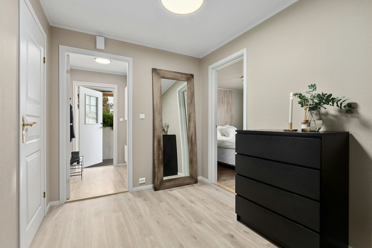A room with a dresser and a mirror