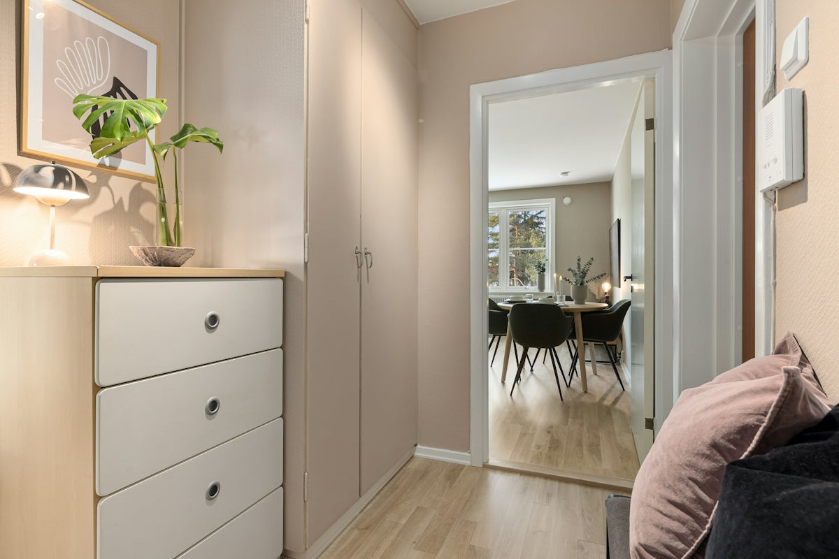 A bedroom with a bed, dresser, and mirror