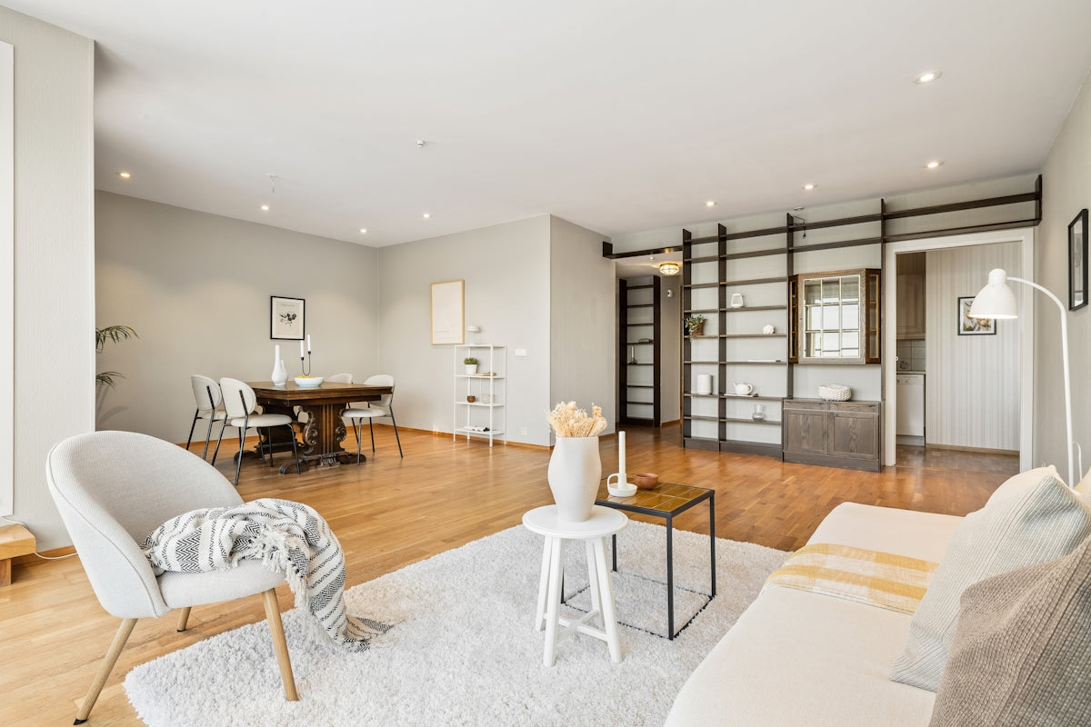 A living room filled with furniture and a wooden floor