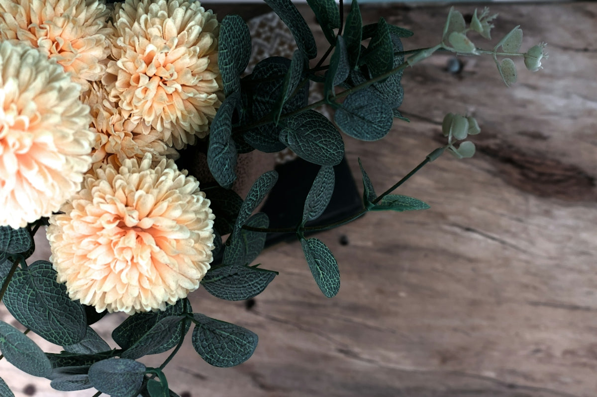 A bunch of flowers sitting on top of a wooden table
