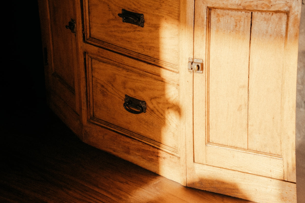 A wooden dresser sitting on top of a hard wood floor