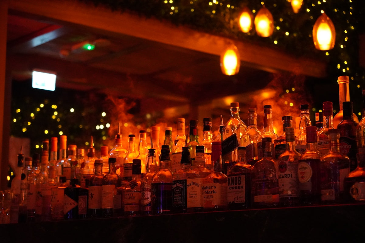 A well-stocked bar with dim lighting.