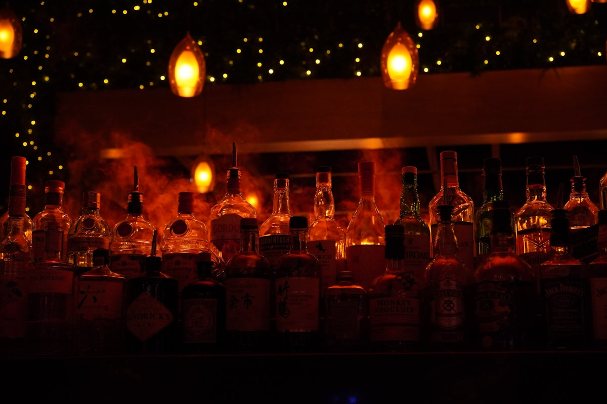 Bottles of liquor at a dimly lit bar.