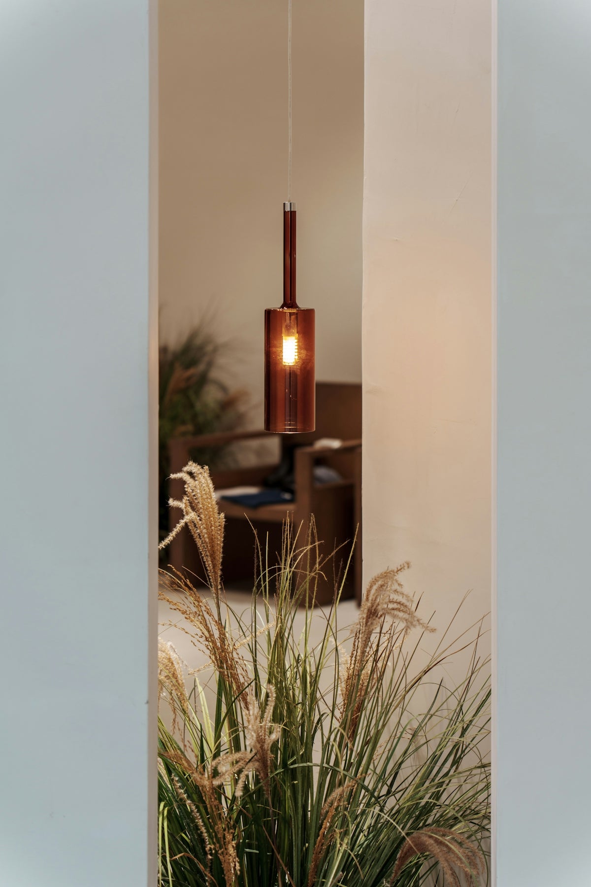 A pendant light illuminates a cozy interior space.