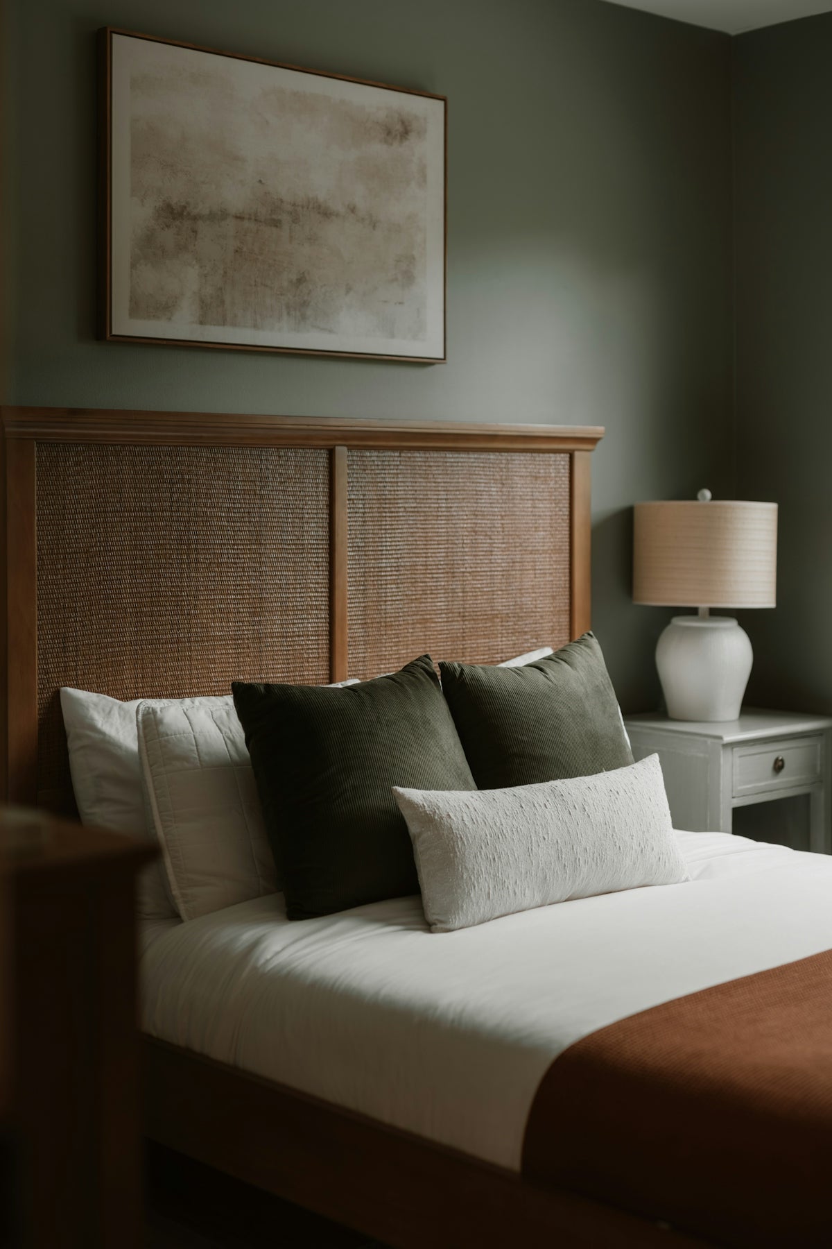 A cozy bedroom with a neatly made bed.