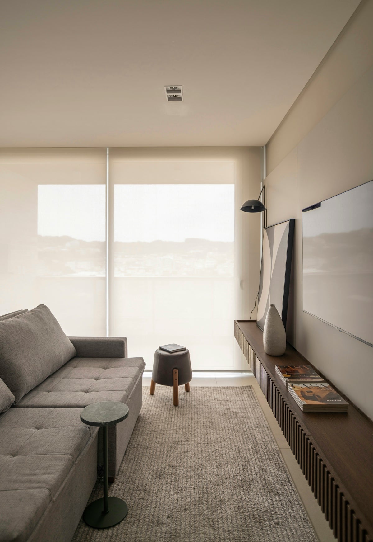 Modern living room with gray sectional sofa and tv.