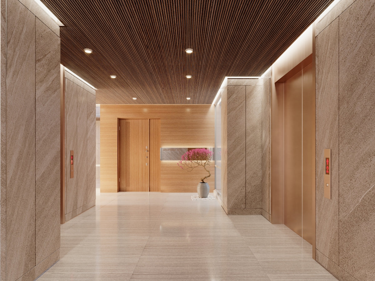 Modern hotel lobby with elevators and wood accents.