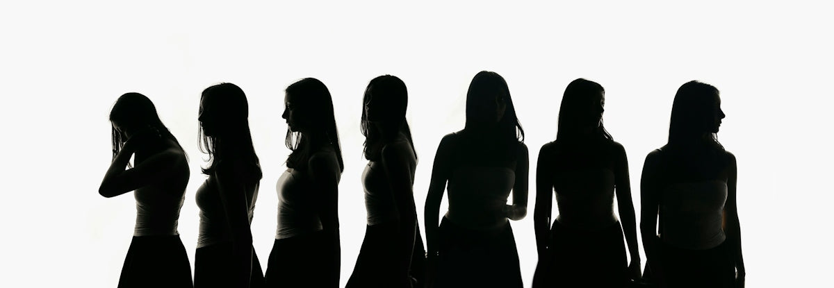 Silhouettes of seven women against a white background.