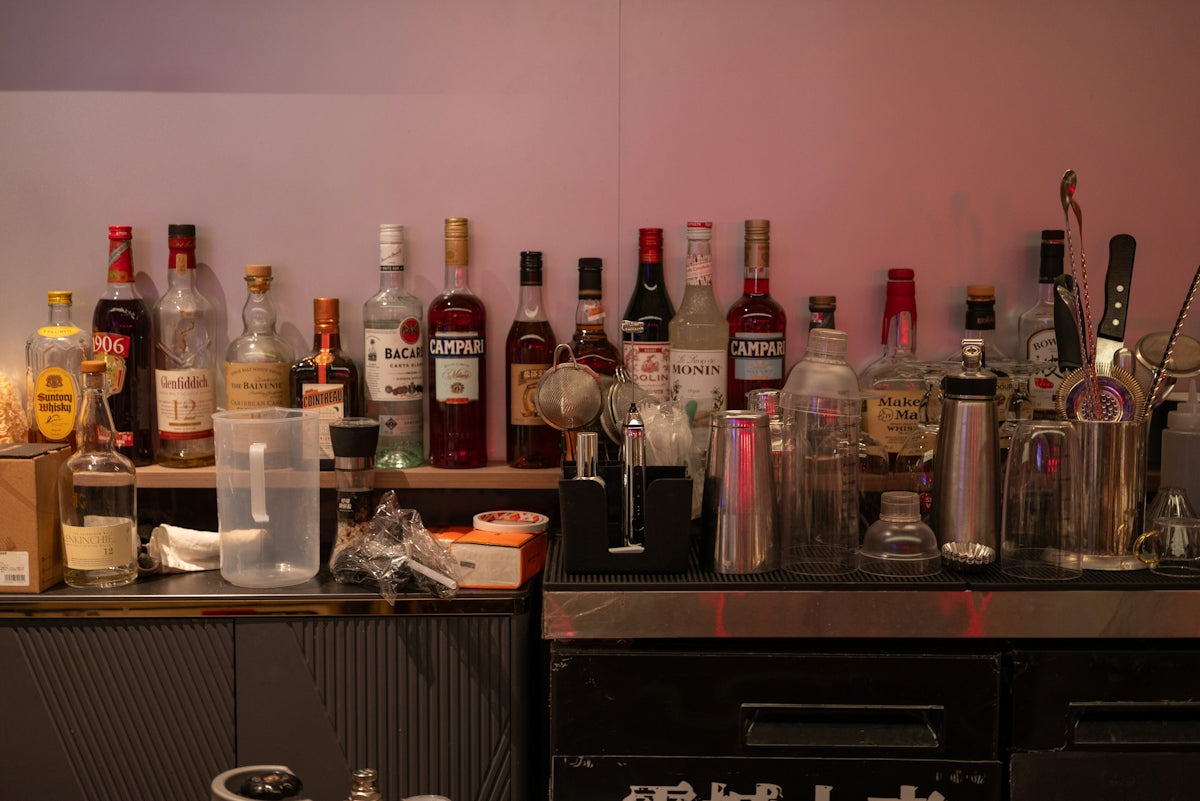 Assortment of liquor bottles on bar shelves
