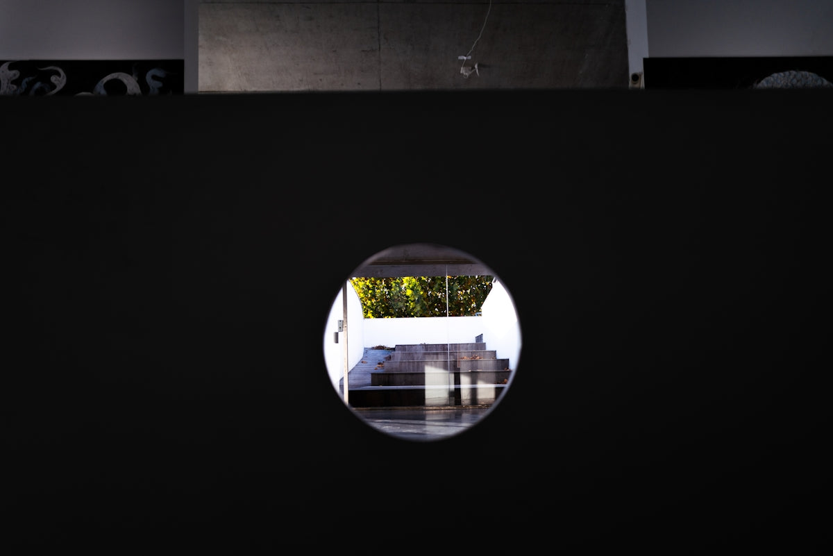 View through a circular opening to a courtyard.