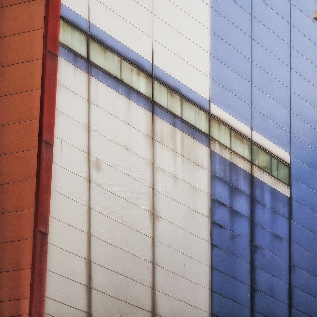 Modern building facade with blue and white panels