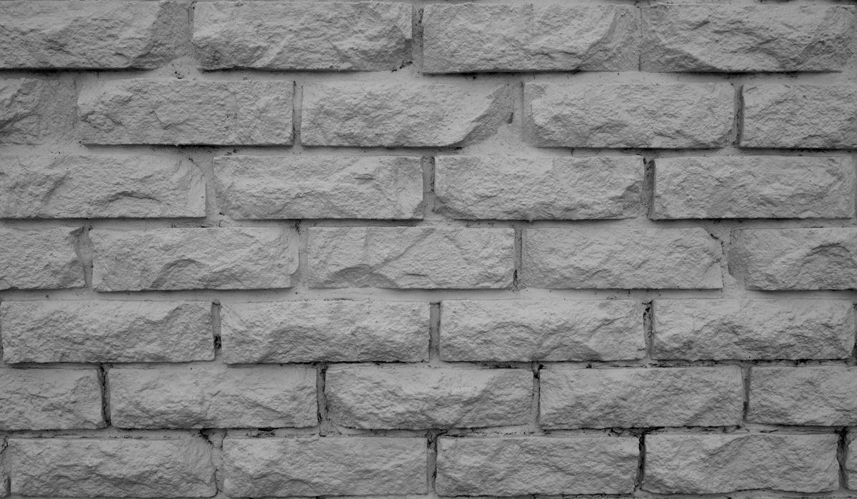 A textured grey brick wall pattern