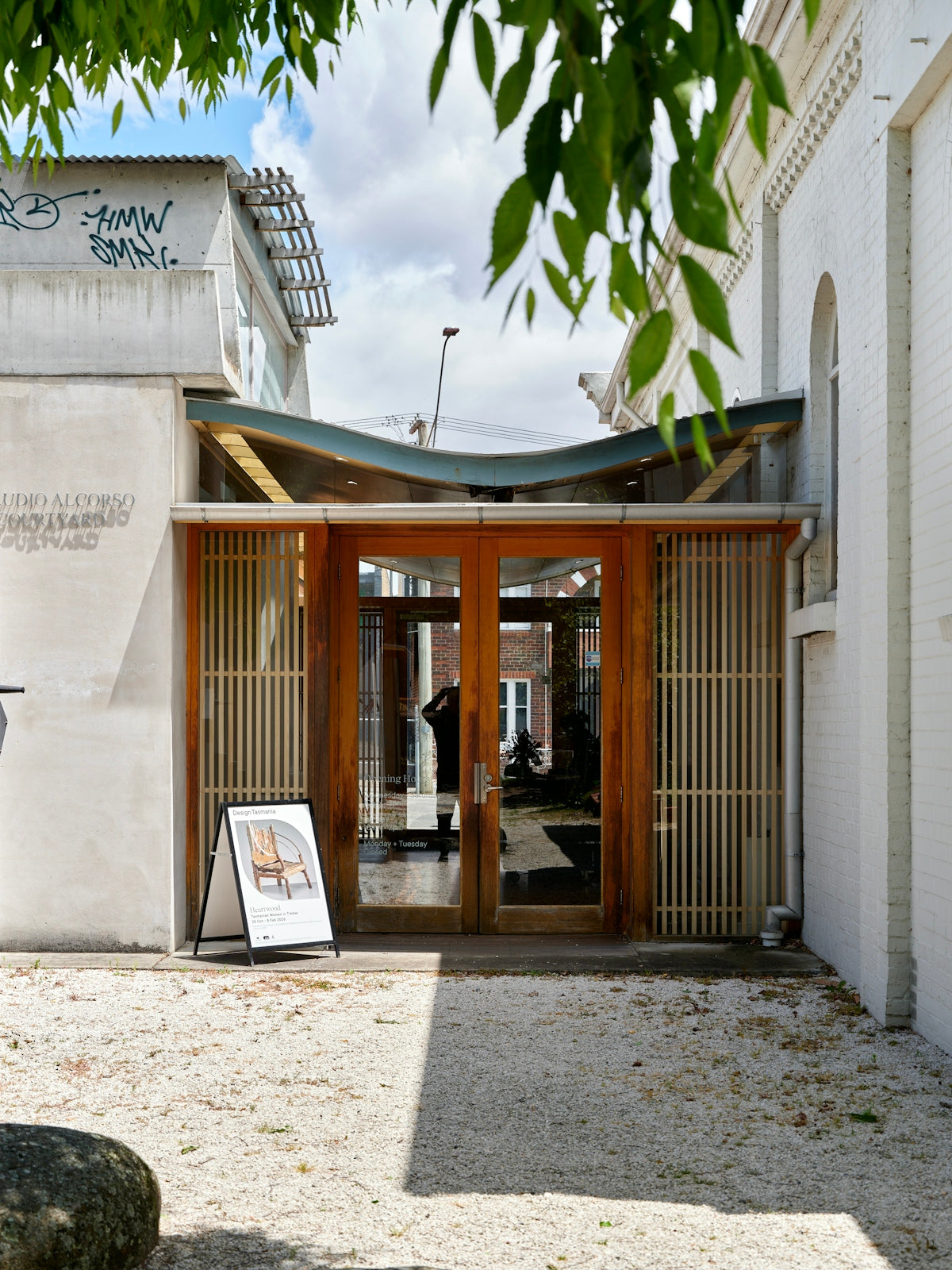 Modern building entrance with wooden doors and signage