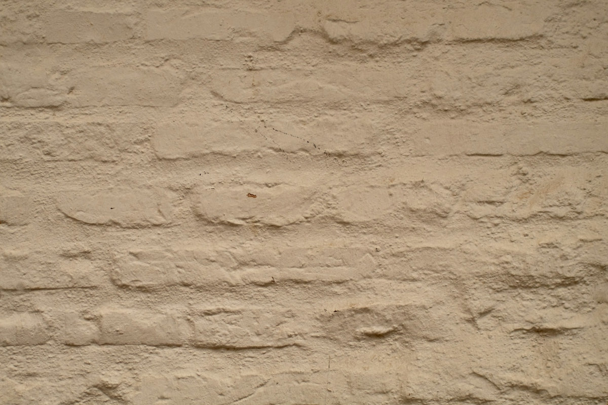 A textured beige brick wall