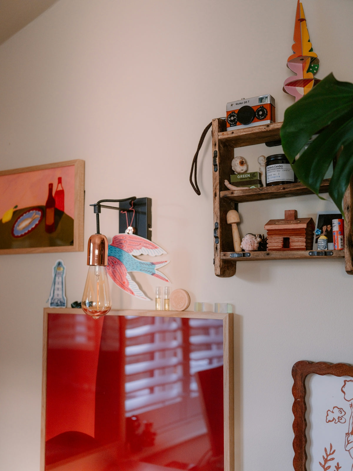 Shelves with decorative items and artwork on wall.