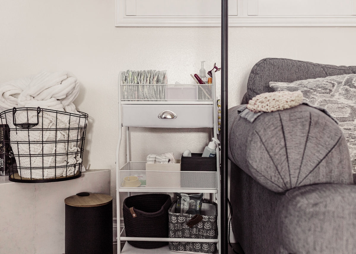 Storage cart with baskets next to sofa