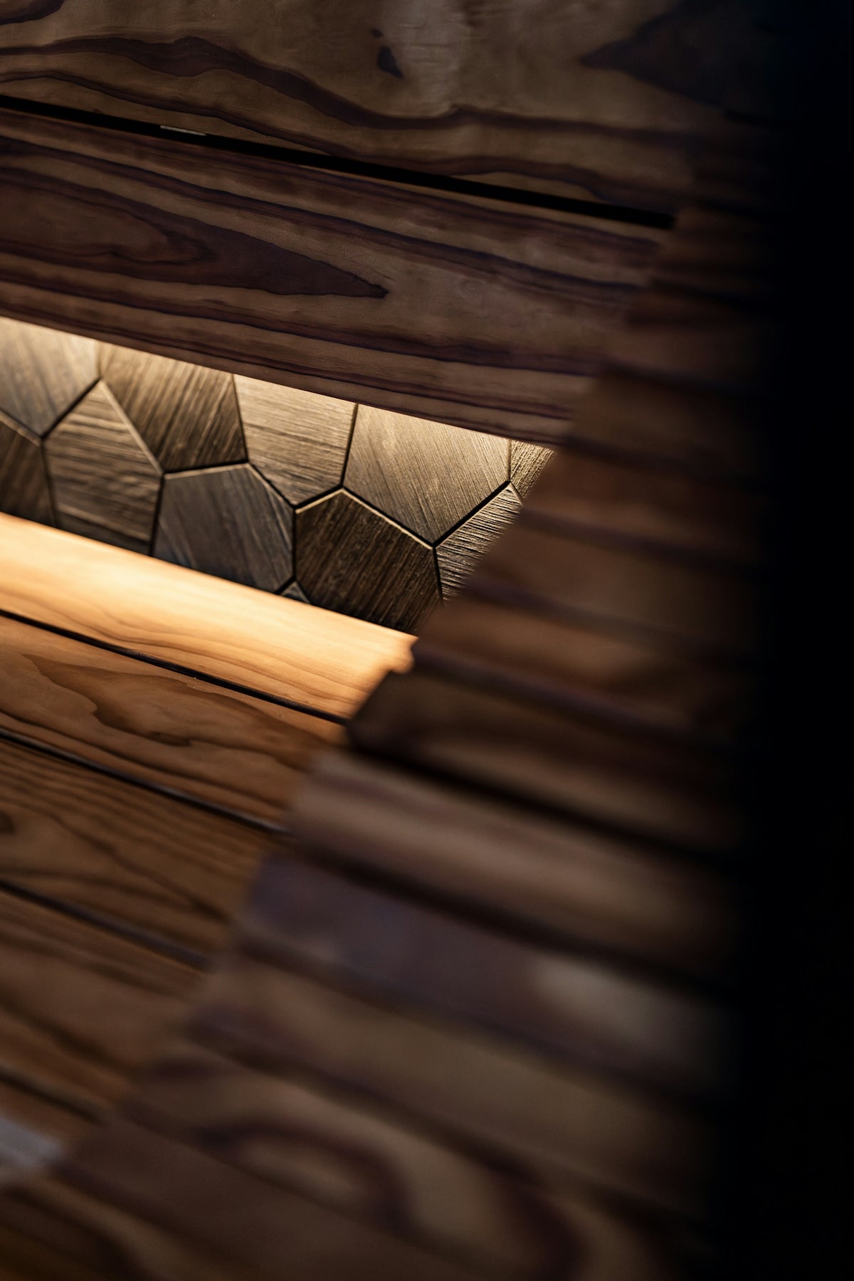 Textured wooden wall with geometric pattern and lighting