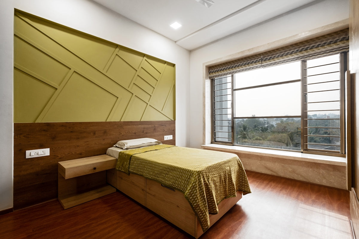 A modern bedroom with a large window and bed.
