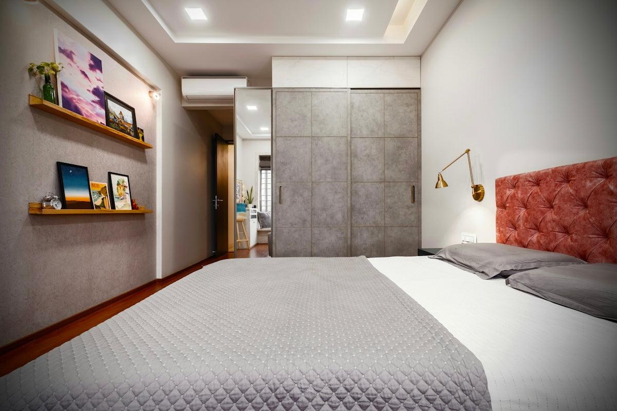 Modern bedroom with large wardrobe and bed.