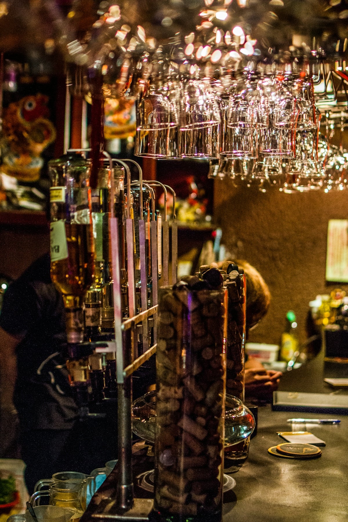 Bar counter with hanging wine glasses and liquor bottles