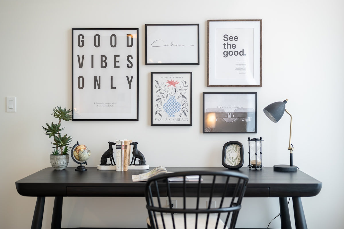 Desk with framed art and office supplies
