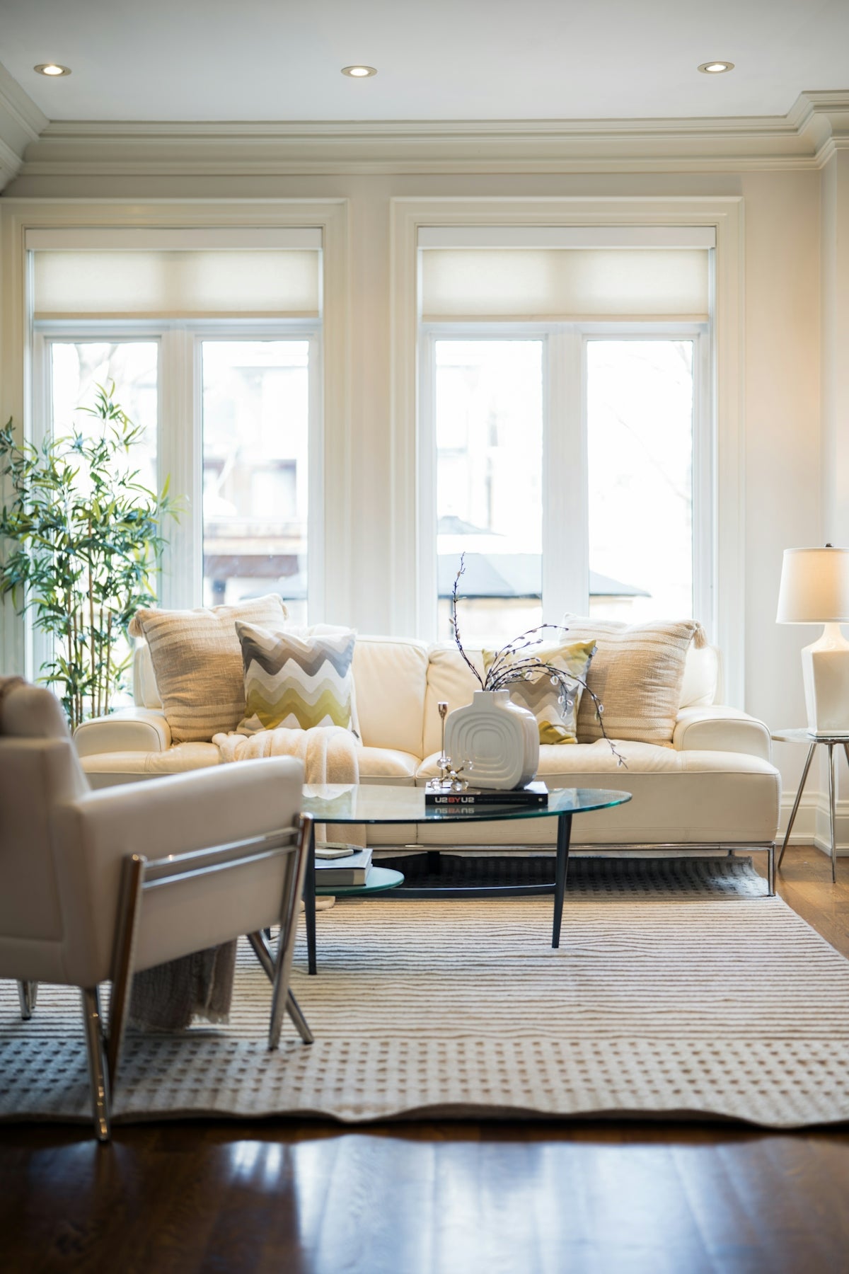A bright, modern living room with a sofa and armchair.