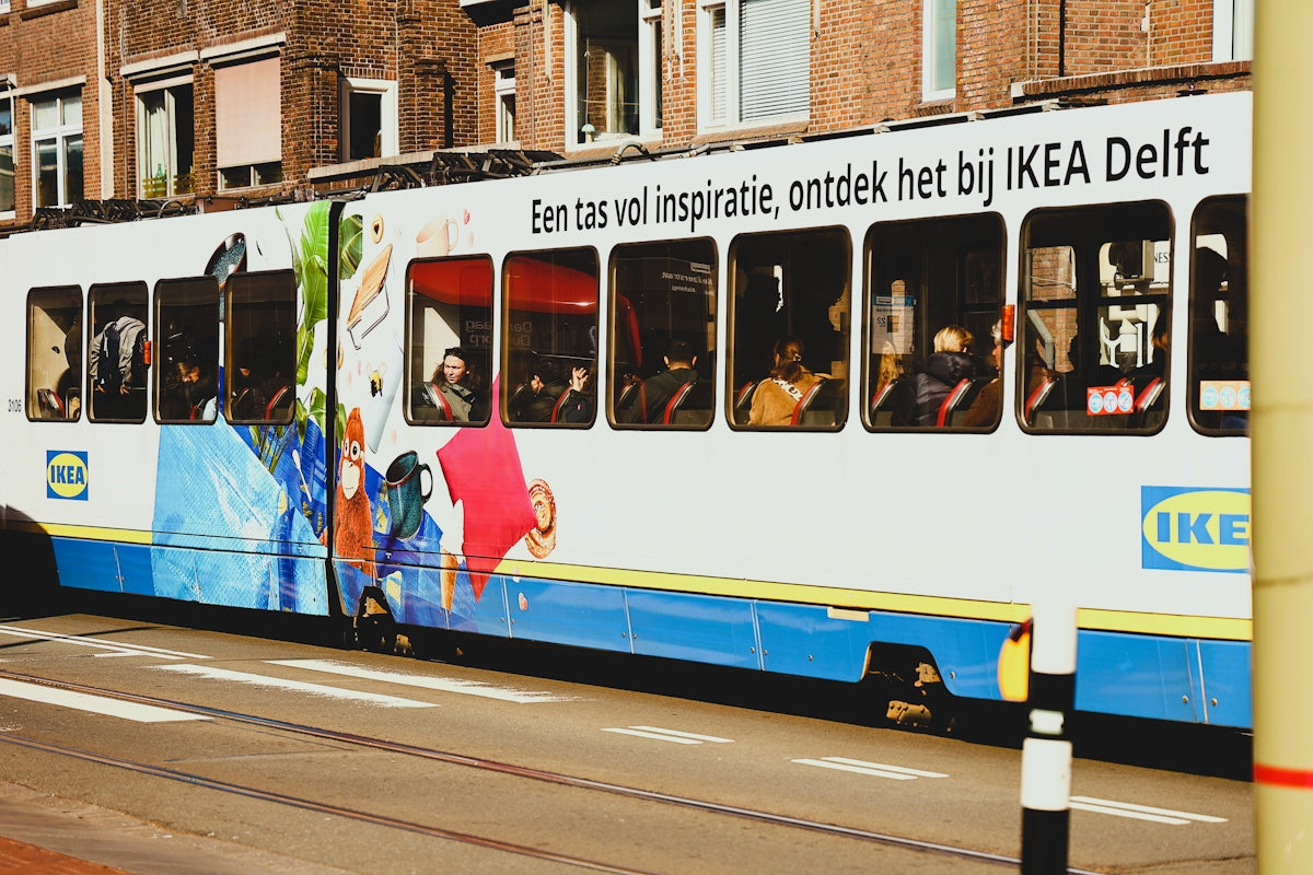 Tram with ikea delft advertisement driving on street