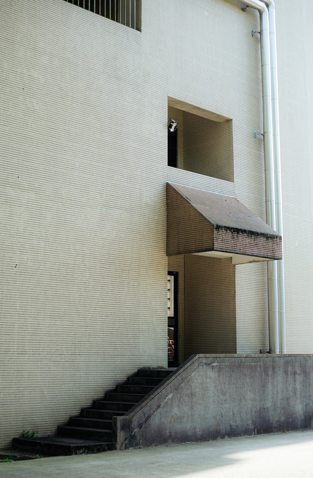 Concrete stairs lead to an open doorway.